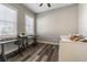 Bedroom featuring hardwood floors, a desk with chairs, and a bed next to a window at 6010 Kipps Colony E Dr, Gulfport, FL 33707