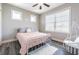 A bright bedroom features a modern ceiling fan, cozy hammock chair, and natural light at 6010 Kipps Colony E Dr, Gulfport, FL 33707