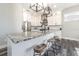 Modern kitchen features white cabinets, a granite island with bar seating, and stainless steel appliances at 6010 Kipps Colony E Dr, Gulfport, FL 33707