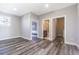 An open living room connects the bedroom, bathroom, and laundry room with modern flooring at 6010 Kipps Colony E Dr, Gulfport, FL 33707