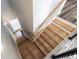 A modern staircase with wooden steps, white risers, and a decorative cable railing at 6010 Kipps Colony E Dr, Gulfport, FL 33707