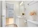 Cozy bathroom with white vanity and cabinets, with access to a bedroom visible in the background at 8609 Mallard Reserve Dr # 202, Tampa, FL 33614