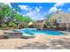 Inviting community pool with a spa and ample seating on a paved patio at 8609 Mallard Reserve Dr # 202, Tampa, FL 33614