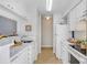 Galley-style kitchen with white appliances and wood-look flooring at 8609 Mallard Reserve Dr # 202, Tampa, FL 33614