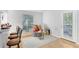Cozy living room with wood-look floors, breakfast bar, and access to the outdoors at 8609 Mallard Reserve Dr # 202, Tampa, FL 33614