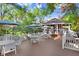 Outdoor patio with seating, umbrellas, and lush greenery at 8609 Mallard Reserve Dr # 202, Tampa, FL 33614