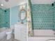 Bright bathroom with teal tile shower and bathtub at 1002 Ibis Ct, Dunedin, FL 34698