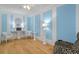 Living room with light wood floors and blue walls at 1002 Ibis Ct, Dunedin, FL 34698