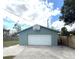 Detached garage with a basketball hoop and a new white door at 1006 N Bask Dr, Tampa, FL 33603