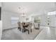 Bright dining room with a table and chairs, adjacent to living area at 11917 Spindrift Loop, Hudson, FL 34667