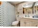 Updated bathroom with white vanity and chevron shower curtain at 1221 Drew St # E11, Clearwater, FL 33755