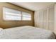 Bedroom featuring a double bed, window with blinds, and built-in closet at 1221 Drew St # E11, Clearwater, FL 33755