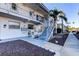 Charming condo exterior with well-maintained landscaping and inviting entry stairs at 1221 Drew St # E11, Clearwater, FL 33755