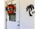 White front door decorated with a Christmas wreath at 1221 Drew St # E11, Clearwater, FL 33755