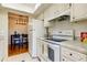 White kitchen features granite countertops and black appliances at 1221 Drew St # E11, Clearwater, FL 33755