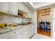 Kitchen featuring white cabinets, stainless steel sink, and adjacent dining area at 1221 Drew St # E11, Clearwater, FL 33755