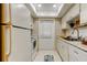 Galley kitchen with white cabinets, stainless steel appliances, and door to outside at 1221 Drew St # E11, Clearwater, FL 33755