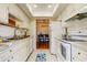 Bright eat-in kitchen with white cabinets and granite countertops at 1221 Drew St # E11, Clearwater, FL 33755