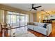 Bright living room with hardwood floors, comfy sofa, and access to a sunroom at 1221 Drew St # E11, Clearwater, FL 33755
