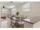 Cozy dining area with glass-top table and chairs, adjacent to kitchen at 1303 E Frierson Ave, Tampa, FL 33603