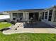 Home with solar panels, patio, and grassy backyard at 1707 New Bedford Dr, Sun City Center, FL 33573