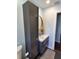 Bathroom with modern vanity, tall cabinet, and floor tile at 1707 New Bedford Dr, Sun City Center, FL 33573
