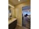 Updated bathroom with vanity and view of bedroom at 1707 New Bedford Dr, Sun City Center, FL 33573