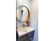 Modern bathroom with floating vanity and large round mirror at 1707 New Bedford Dr, Sun City Center, FL 33573