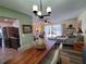 Open concept dining area with wood table and view into living room and kitchen at 1707 New Bedford Dr, Sun City Center, FL 33573
