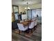 Elegant dining room features a wood table, neutral chairs, and view to backyard at 1707 New Bedford Dr, Sun City Center, FL 33573