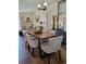 Bright dining room with wood table and modern chairs, offering an open floor plan at 1707 New Bedford Dr, Sun City Center, FL 33573