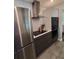 Modern kitchen features stainless steel appliances and sleek dark cabinetry at 1707 New Bedford Dr, Sun City Center, FL 33573