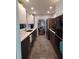 Modern kitchen boasts sleek dark cabinetry, quartz countertops, and stainless steel appliances at 1707 New Bedford Dr, Sun City Center, FL 33573