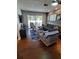 Cozy living room with comfortable seating, wood floors and access to a patio at 1707 New Bedford Dr, Sun City Center, FL 33573