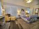 Main bedroom with king-size bed and access to the bathroom at 1707 New Bedford Dr, Sun City Center, FL 33573