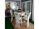 Patio with white metal dining set and green artificial turf at 1707 New Bedford Dr, Sun City Center, FL 33573