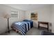 Blue and white striped bedding, wooden nightstand, and brick flooring at 2903 W Walnut St, Tampa, FL 33607