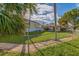 Fenced backyard with grassy area, and a paved patio at 405 16Th Ave, Indian Rocks Beach, FL 33785