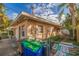 Rear view of house with green recycling bins and gated side yard at 405 16Th Ave, Indian Rocks Beach, FL 33785