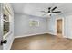 Spacious bedroom with hardwood floors, ceiling fan, and an ensuite bathroom at 4290 Yucatan Cir, Port Charlotte, FL 33948