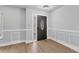 Entryway with dark door and white wainscoting at 4290 Yucatan Cir, Port Charlotte, FL 33948
