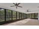 Bright sunroom with light wood floors and ceiling fans at 4290 Yucatan Cir, Port Charlotte, FL 33948