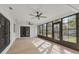 Spacious sunroom with light wood floors and two fans at 4290 Yucatan Cir, Port Charlotte, FL 33948