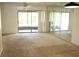 Bright living room with carpet flooring and sliding glass doors at 9209 Seminole Blvd # 67, Seminole, FL 33772