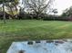 Spacious backyard with grassy lawn and a concrete patio at 9744 Lake Seminole E Dr, Largo, FL 33773