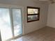 Bedroom with sliding glass doors and window at 9744 Lake Seminole E Dr, Largo, FL 33773