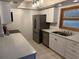 Kitchen with stainless steel appliances and white cabinets at 9744 Lake Seminole E Dr, Largo, FL 33773