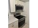 Stainless steel appliances and white cabinets in kitchen at 9744 Lake Seminole E Dr, Largo, FL 33773