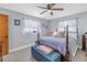 Cozy bedroom featuring a double bed with a four-poster frame and a blue bench at the foot of the bed at 3401 60Th N St, St Petersburg, FL 33710