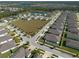 Aerial view of a neighborhood with a large empty lot at 12512 Brick Cobblestone Dr, Riverview, FL 33579